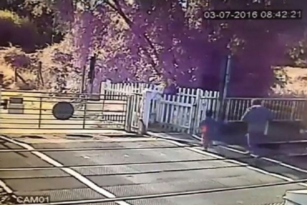 Čovek s detetom pretrčava prugu ispred voza (VIDEO)